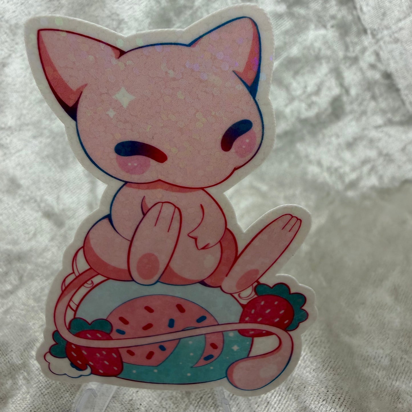 A holographic Mew legendary vinyl sticker with a glittering sparkle holo laminate finish on a clean background.