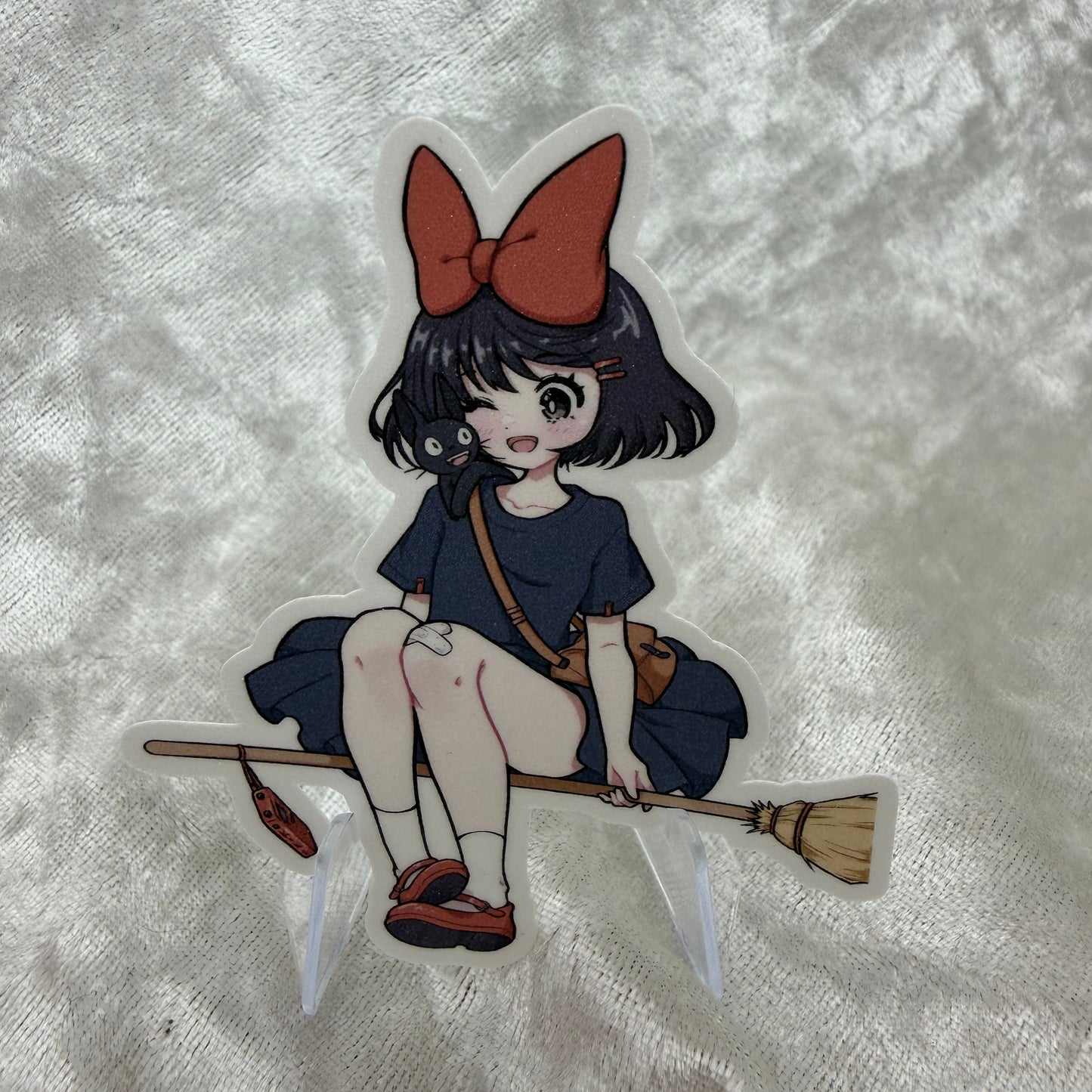 A vinyl sticker of Kiki from the Studio Girls collection with a textured sand glitter sparkle laminate finish on a white background.
