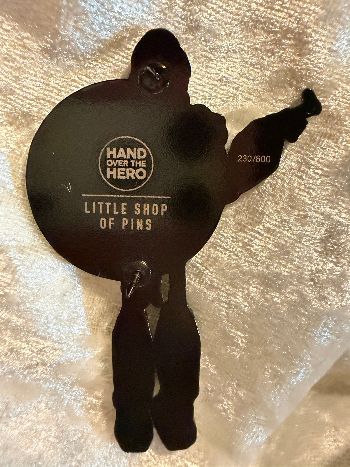 Back of the Iron Giant lapel pin, showing two black rubber clutches for secure fastening.