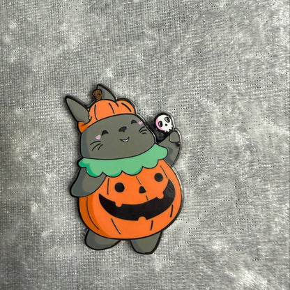 1.5 inch Totoro sitting inside a pumpkin Halloween enamel pin designed by Unicorn Crafts.