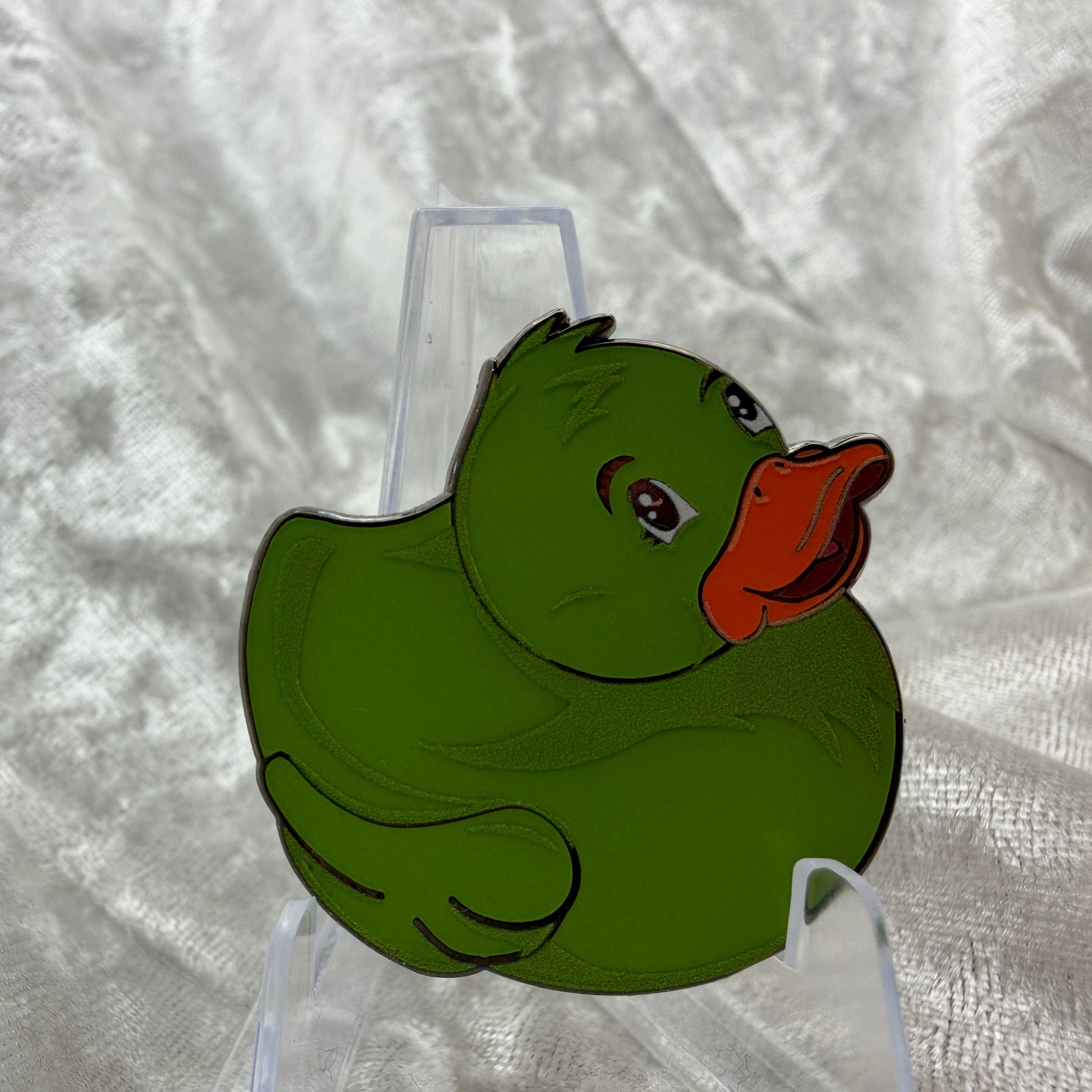 
1.5 inch green glow in the dark duck enamel pin designed by Bendiesticks, limited edition of 30.