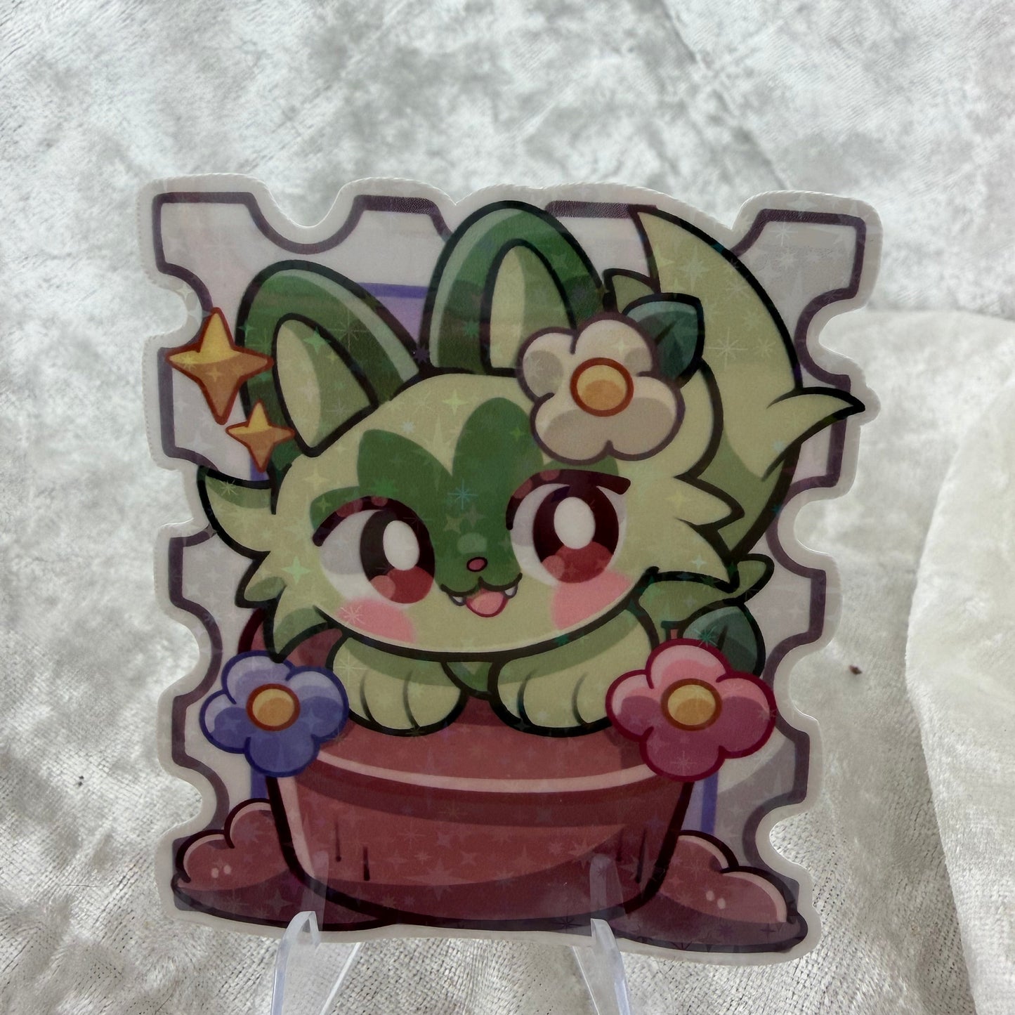 A pastel cat Poke stamp vinyl sticker with a plant design, featuring a sparkling star holographic laminate finish 