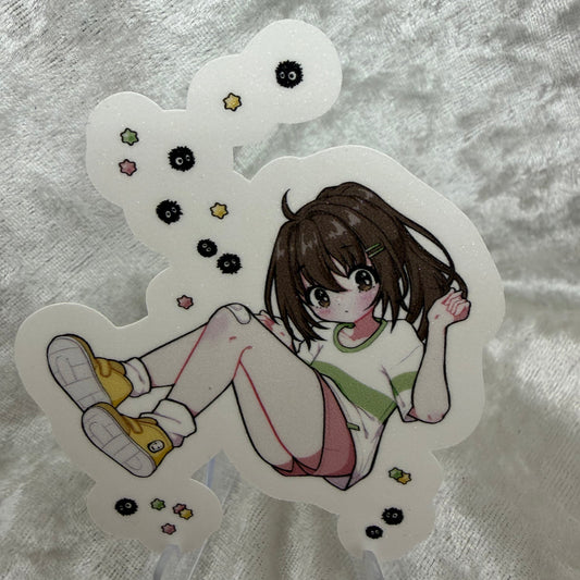 A vinyl sticker of Chi from the Studio Girls collection with a textured sand glitter sparkle laminate finish on a white background.
