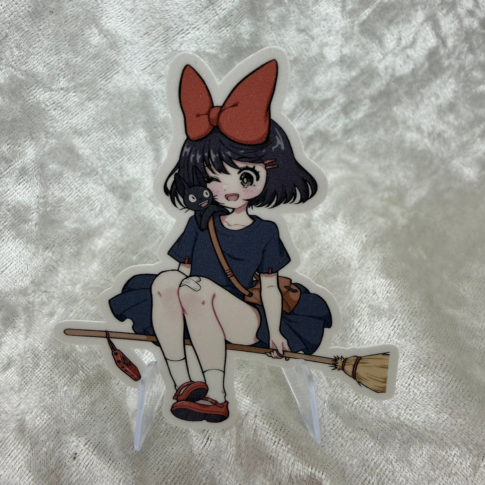 A vinyl sticker of Kiki from the Studio Girls collection with a textured sand glitter sparkle laminate finish on a white background.