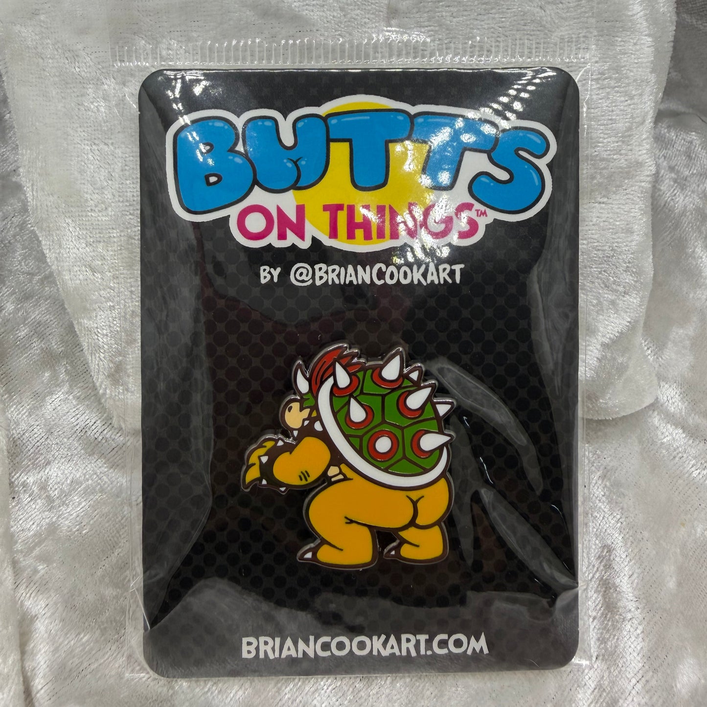 Bowsie Butt Pin by Brian Cook funny spiked shell villain parody enamel pin on backing card
