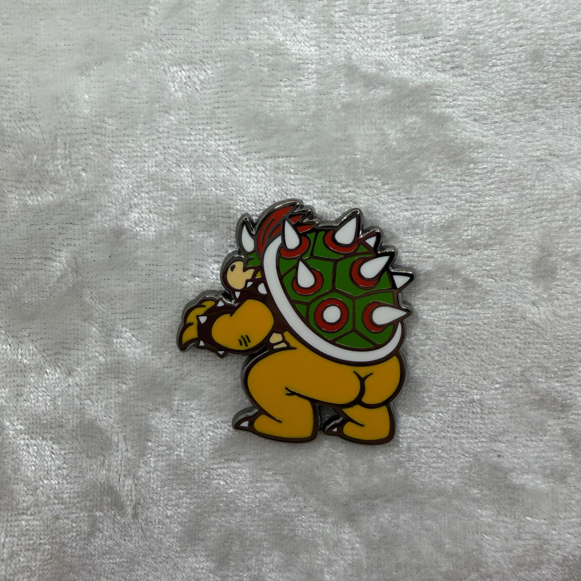 Close-up of Bowsie Butt Pin by Brian Cook, hilarious 1.25 inch gaming boss parody lapel pin