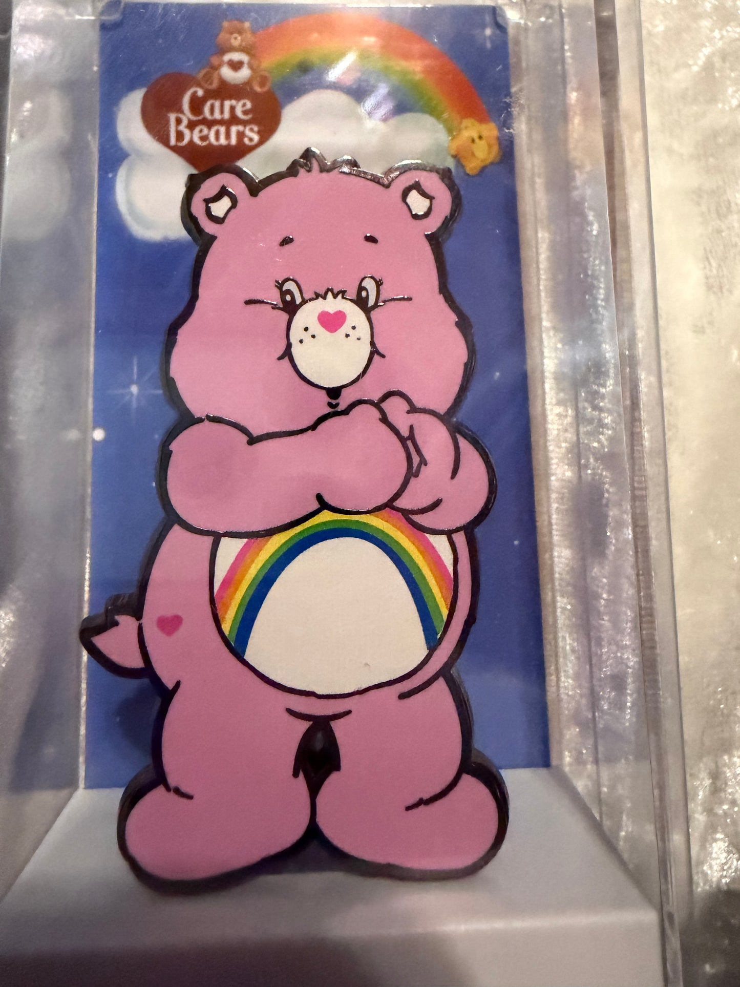 Close-up of Care Bears Cheer Bear FiGPiN #292, officially licensed NYCC 2019 Limited Edition enamel pin