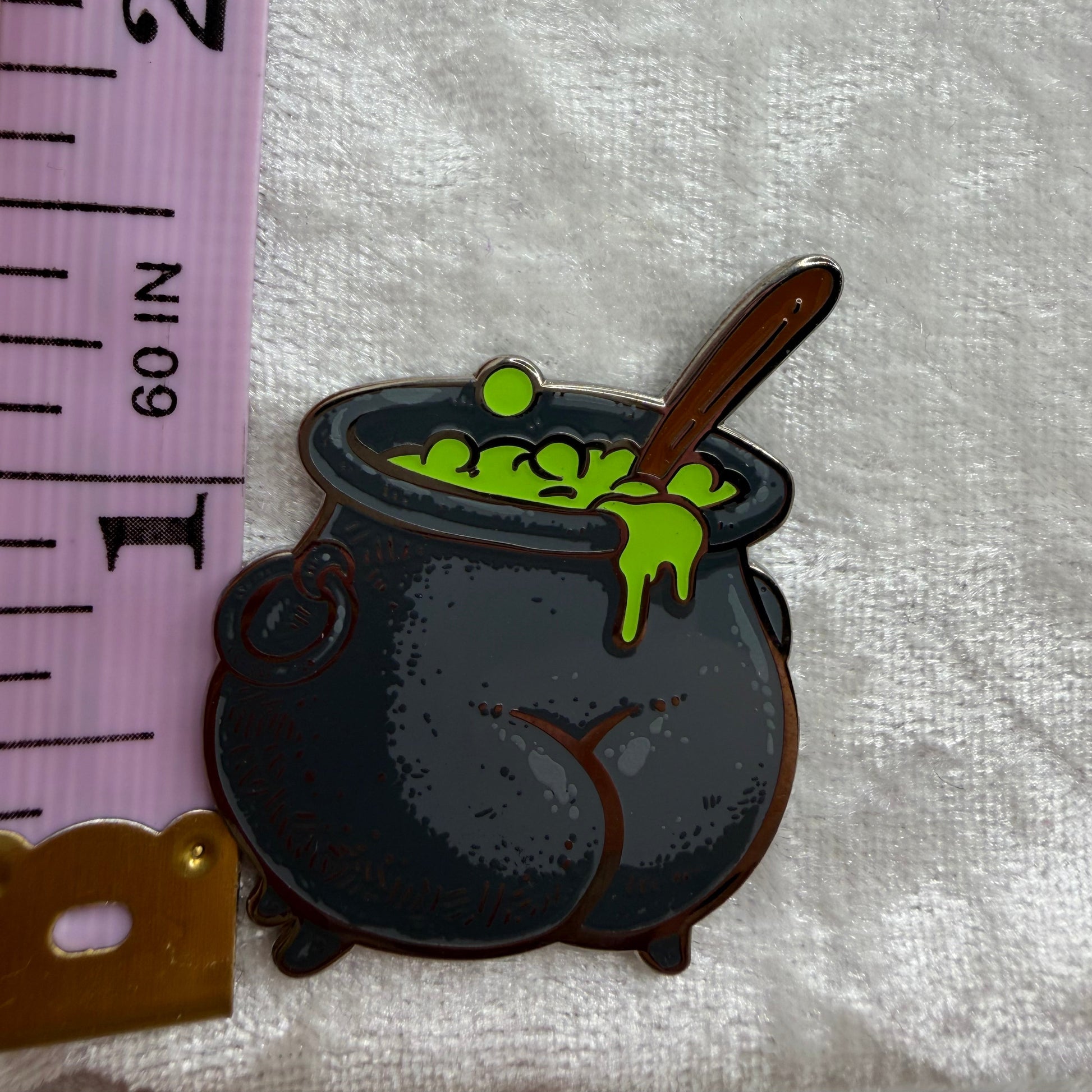 Close-up of Cauldron Butt Pin by Brian Cook, hilarious 1.25 inch spooky parody lapel pin