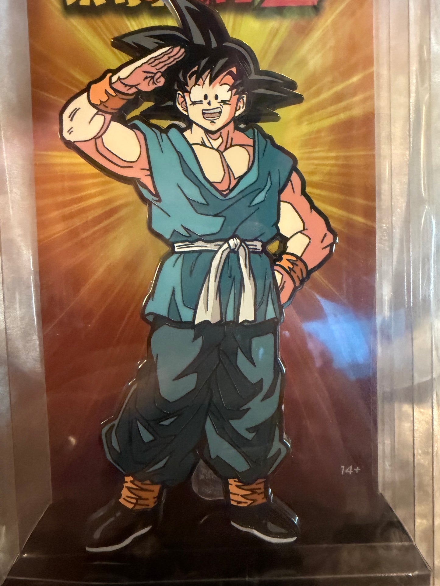 Close-up of Dragon Ball Z Casual Saluting Goku FiGPiN XL #X27 in soft plastic display box, officially licensed collectible