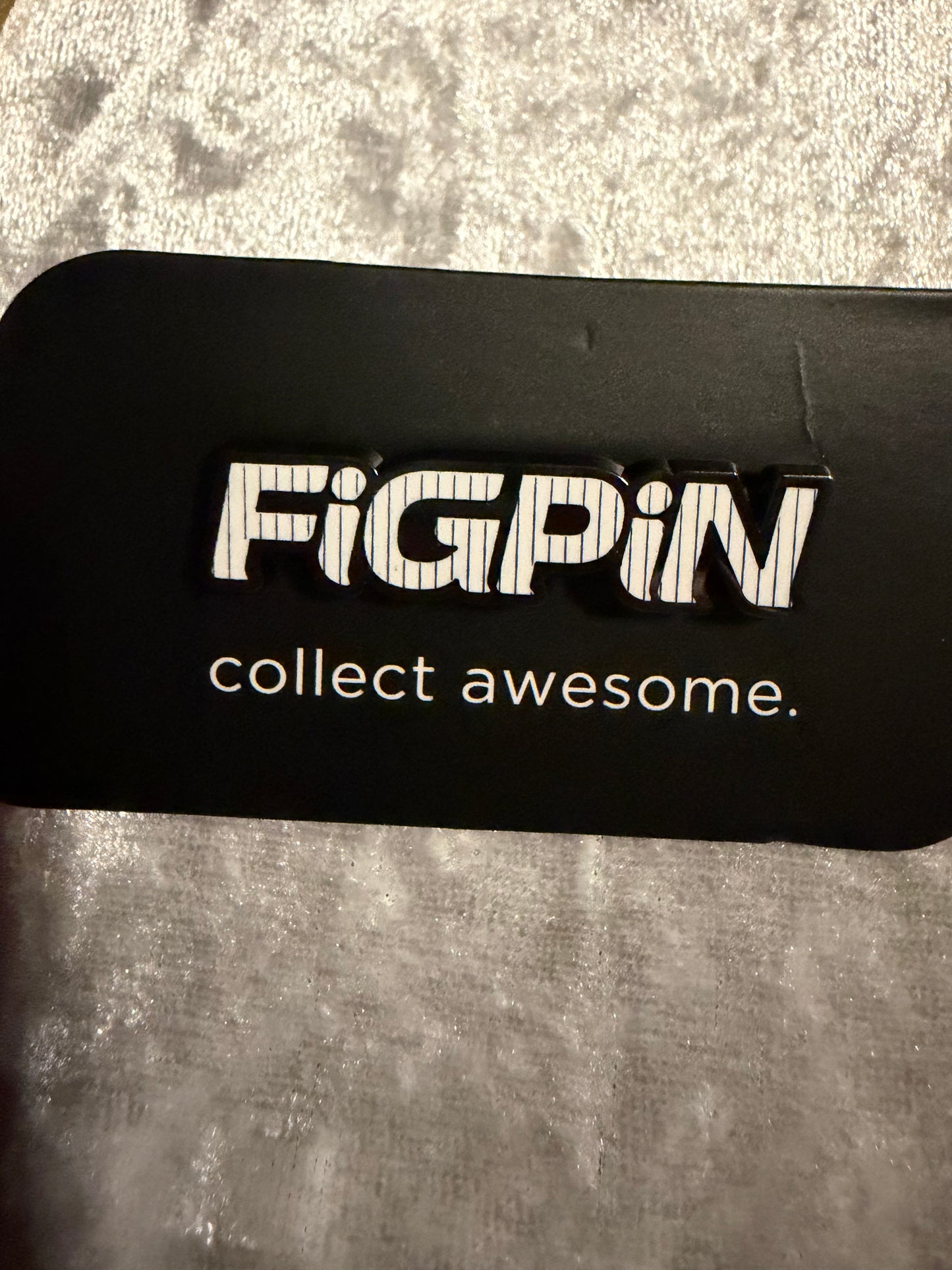 Close-up of FiGPiN Logo Pin L15 Blue NYC Stripes, New York Comic Con 2019 Exclusive Limited Edition of 1000