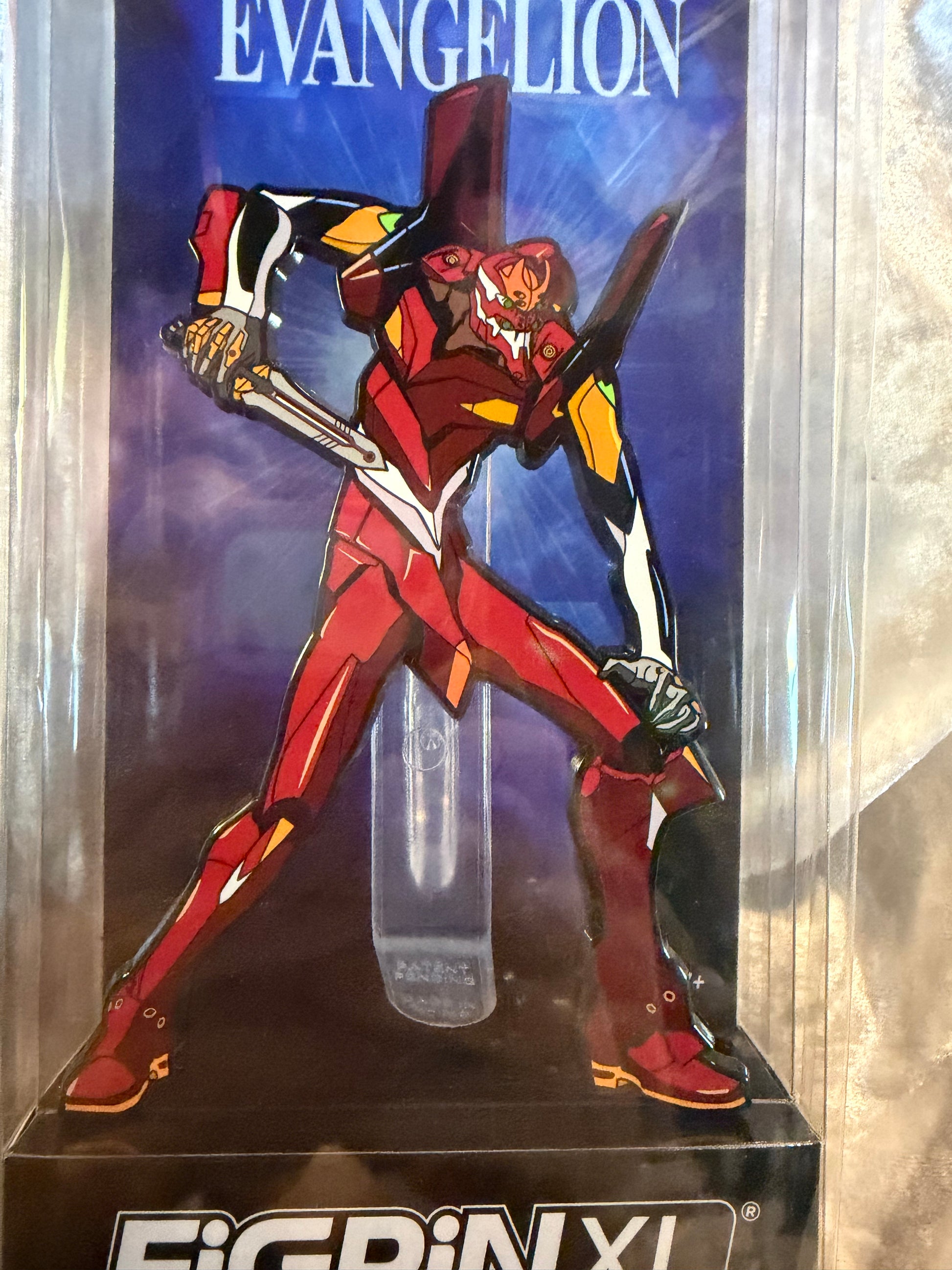 Close-up of Neon Genesis Evangelion EVA Unit 02 FiGPiN XL #X36 in soft plastic display box, officially licensed collectible