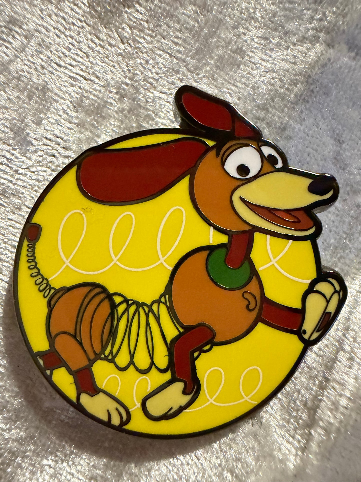 Close-up of Slinky Dog FiGPiN Mini #Y1057 from Toy Story, officially licensed enamel pin