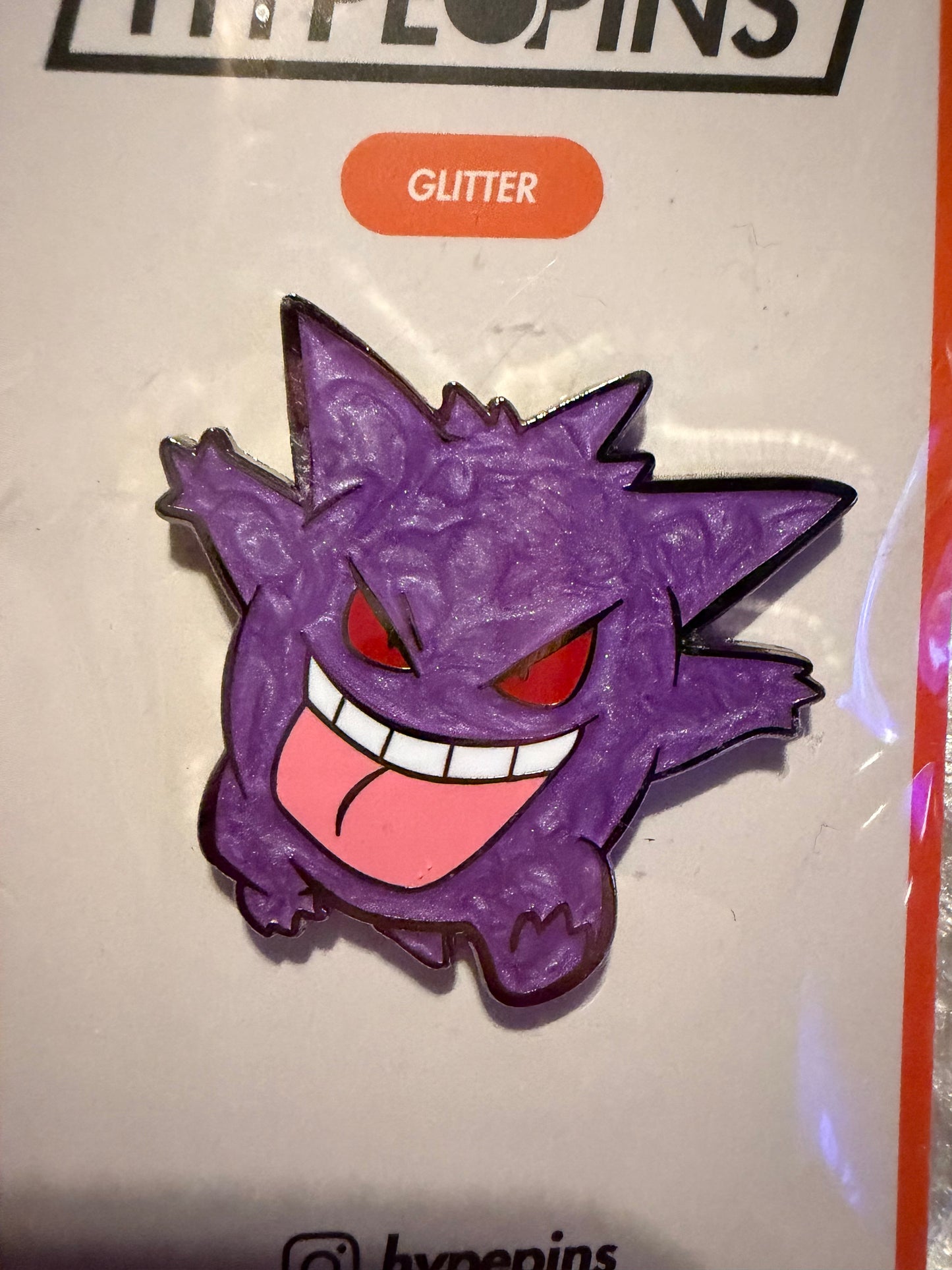 Close-up of the **Gengar Hard Enamel Pin**, showcasing its mischievous expression, crisp hard enamel finish, and subtle **pearl accents**. A detailed Pokémon collectible by Hype Pins.