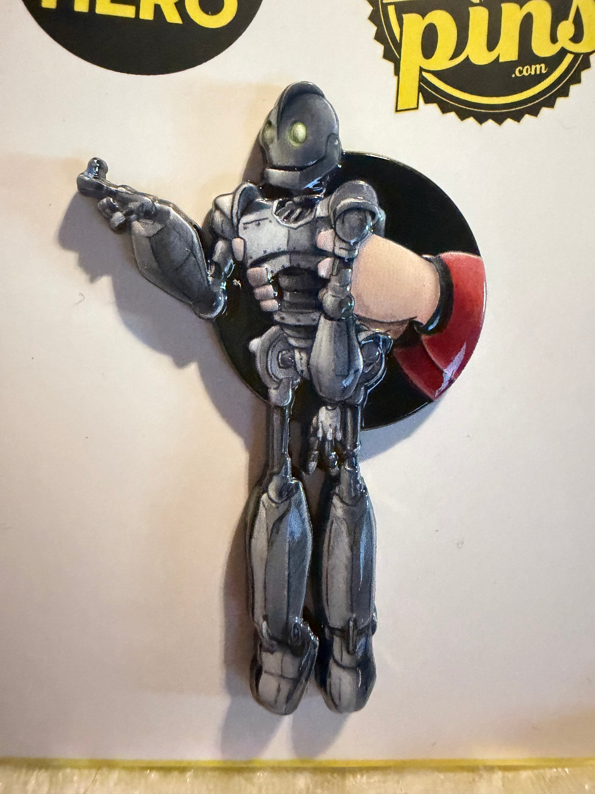Close-up of the Iron Giant collectible pin showing intricate 3D molding and UV print details.