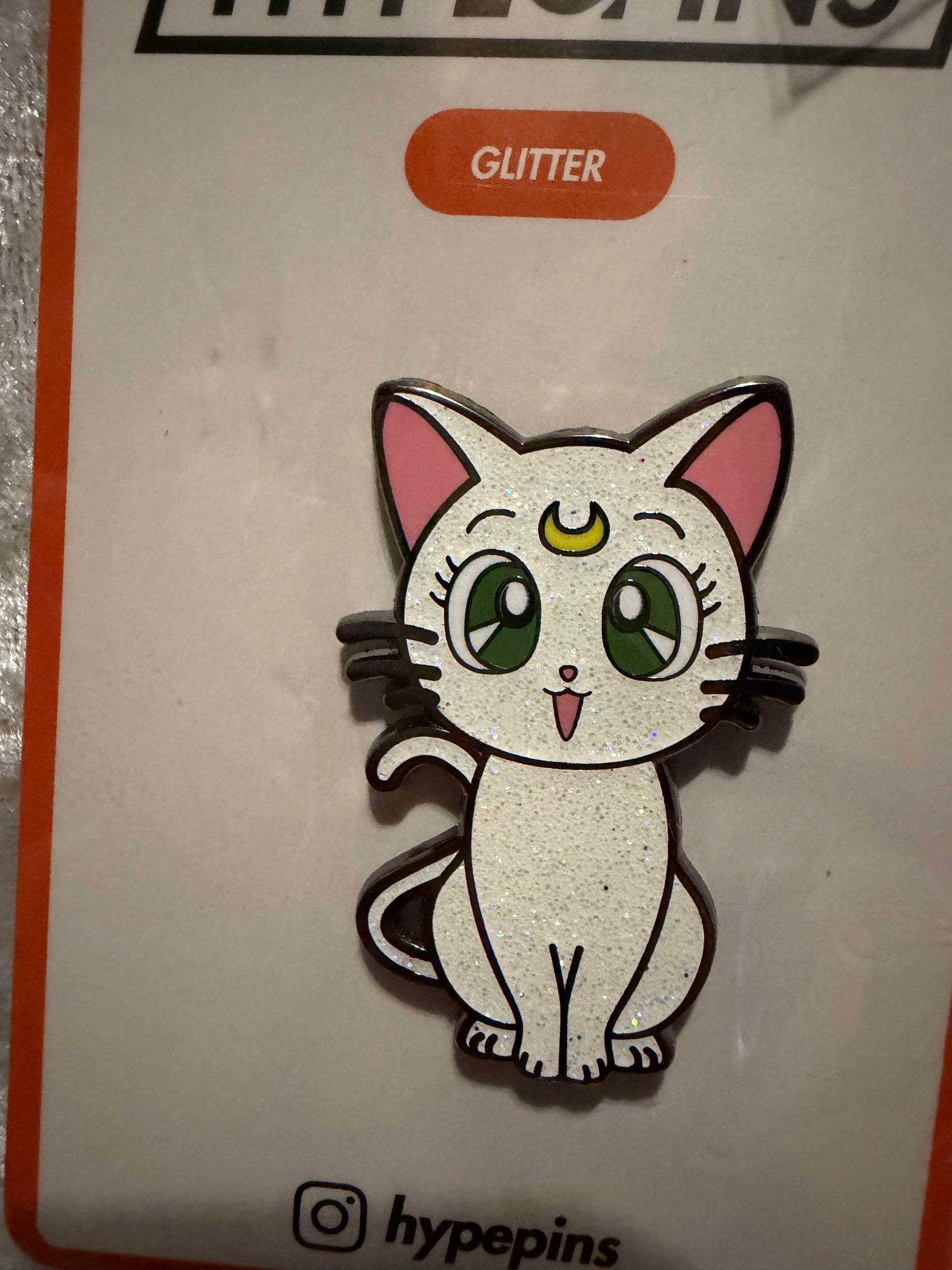 Close-up of the **Sailor Moon Cat Artemis Hard Enamel Pin**, showcasing its loyal expression, crisp hard enamel finish, and black nickel metal outline. A detailed anime collectible by Hype Pins.