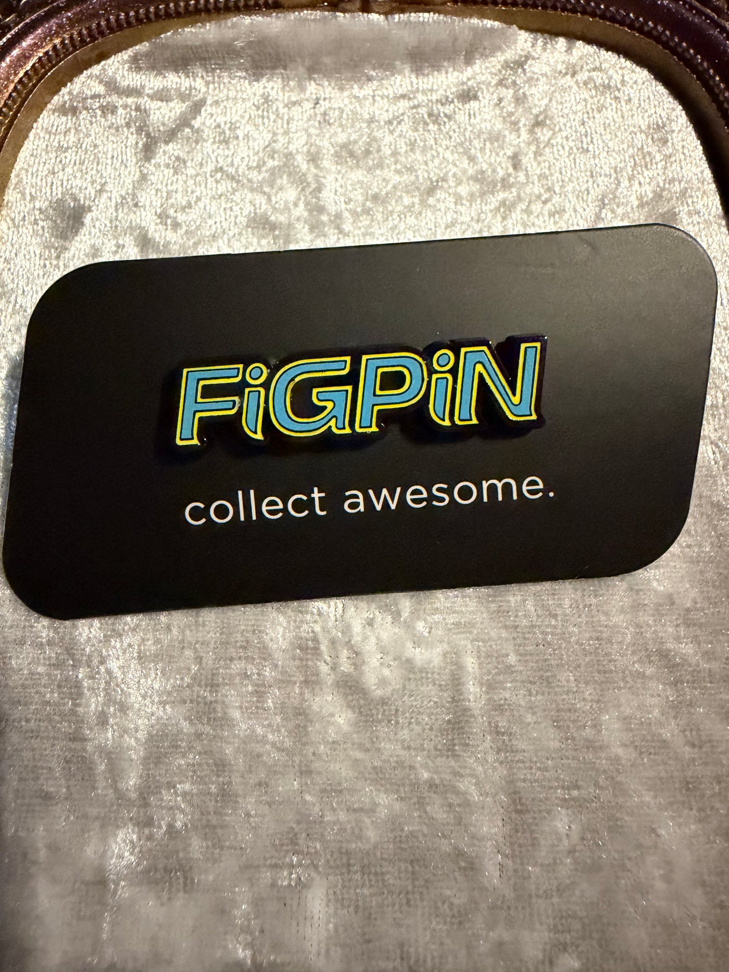 FiGPiN Logo L63 Blue & Yellow On Black LE 1000 collectible pin (from Batman Box Set) on collector card with rubber backer