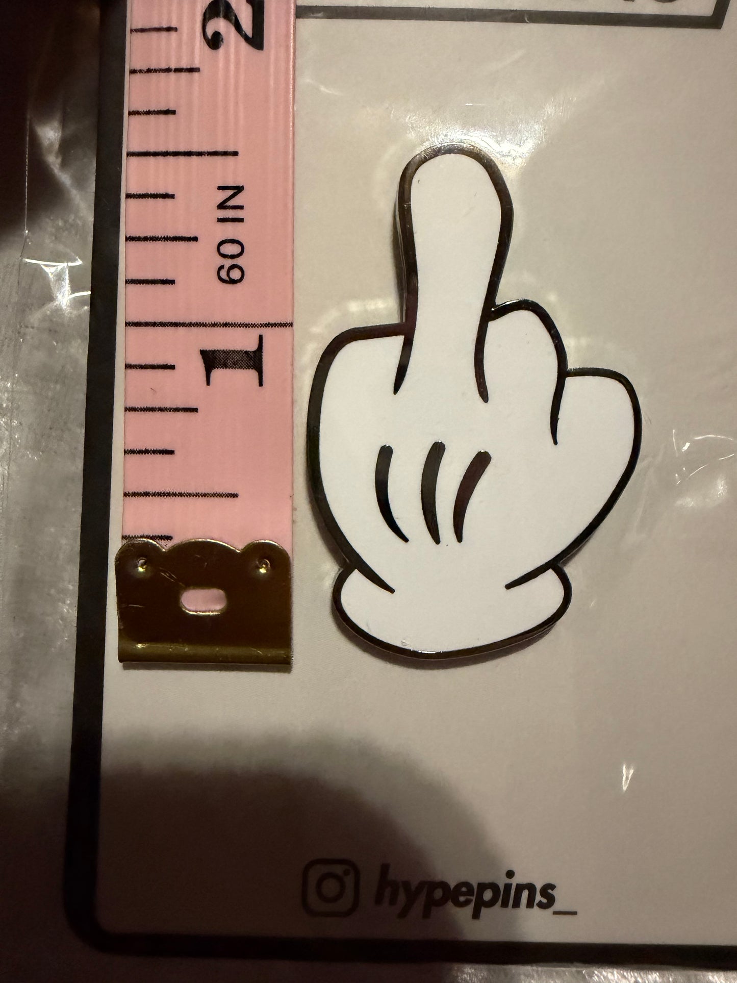 Mickey "the Bird" Hard Enamel Pin by Hype Pins, displayed next to a tape measure to show its **1.5-inch size**. This expressive pop culture collectible features a durable hard enamel finish.