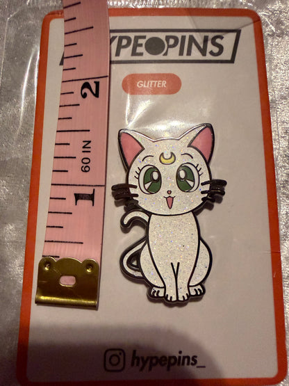 Sailor Moon Cat Artemis Hard Enamel Pin by Hype Pins, displayed next to a tape measure to show its **1.5-inch size**. This iconic anime collectible features a durable hard enamel finish.