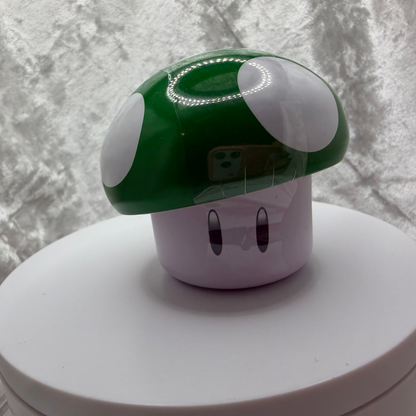 Super Mario Bros green mushroom tin filled with sour green apple candies