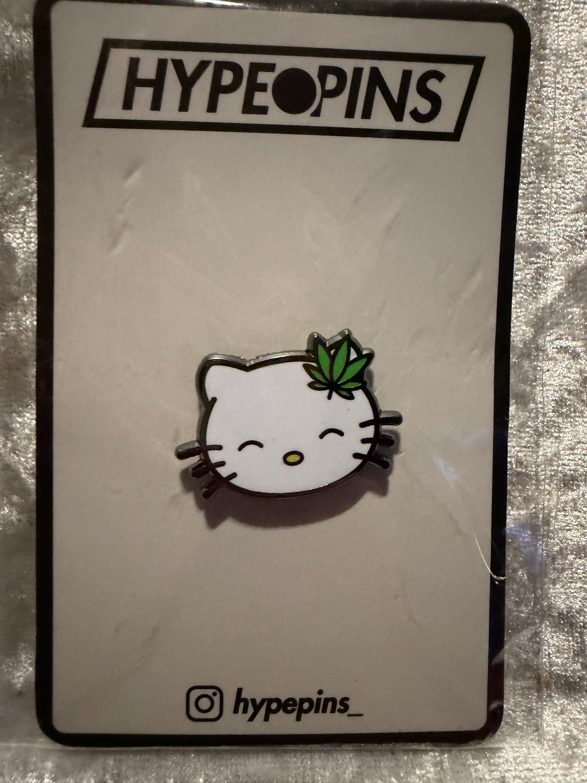The **Hello Litty Hard Enamel Pin** by Hype Pins, a charming and expressive **pop culture art collectible** with a secure backing, ready for display.