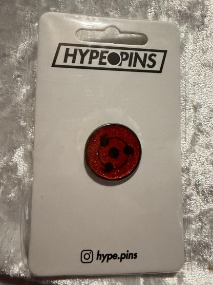 The **Sharingan Obito Hard Enamel Pin**, a compact and powerful **Naruto Uchiha collectible** by Hype Pins, showcasing Obito's iconic Sharingan eye.